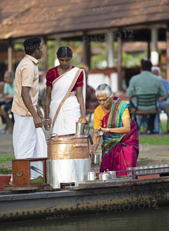 Tealady, 83 years old, making Indian tea on her boat, Backwaters, Kumarakom, Kerala, India, Asia