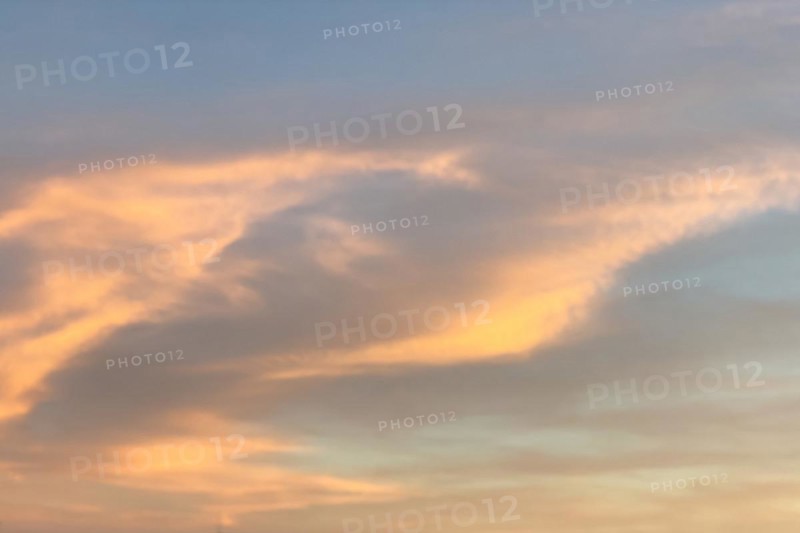 Altostratus Cirrus clouds are illuminated yellow orange by setting sun colourful colourful illuminated, Germany, Europe