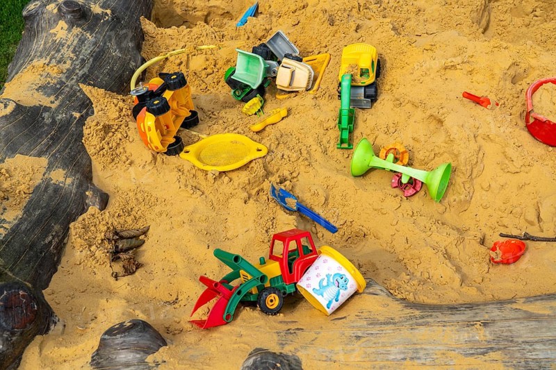 Sandpit, on a children's playground, sandpit with various plastic toys, excavator, shovels, moulds Sauerland, North Rhine-Westphalia, Germany, Europe