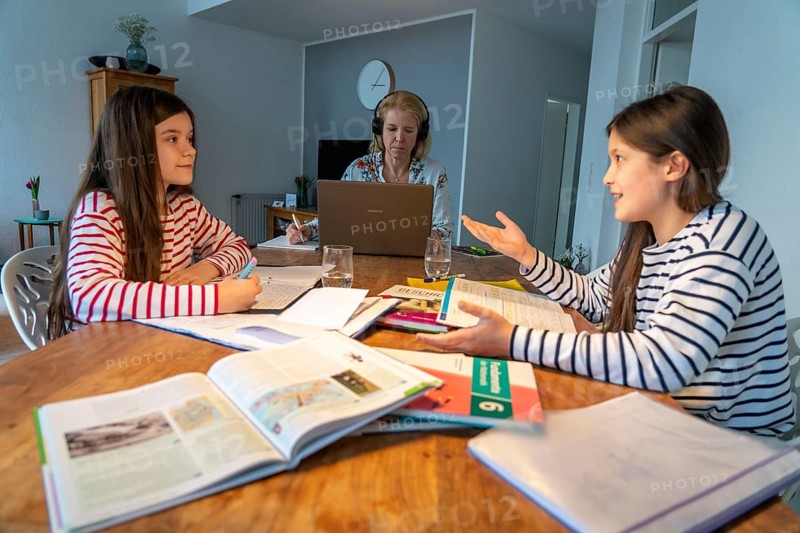 Homeschooling, during the lockdown in January 2021, children learn at home for school, their mum is in the home office and works on the laptop with video chat, school closures, distance learning, effects of the corona crisis in Germany