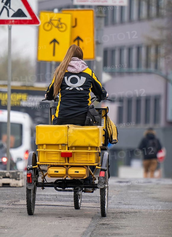 Deutsche Post delivery woman on an electric post tricycle