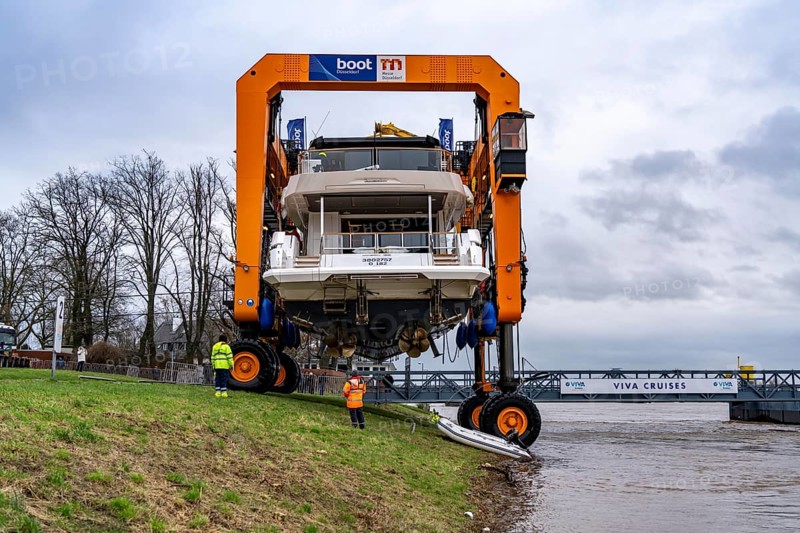 Craning the €6.3 million Sunseeker 88Y motor yacht, weighing 82 tonnes, in preparation for the world's largest water sports trade fair, Boot in Düsseldorf, luxury yachts are driven across the Rhine to the trade fair and brought ashore with the help of the Big Willi ship crane and transported to the exhibition halls on a low-loader, North Rhine-Westphalia, Germany, Europe