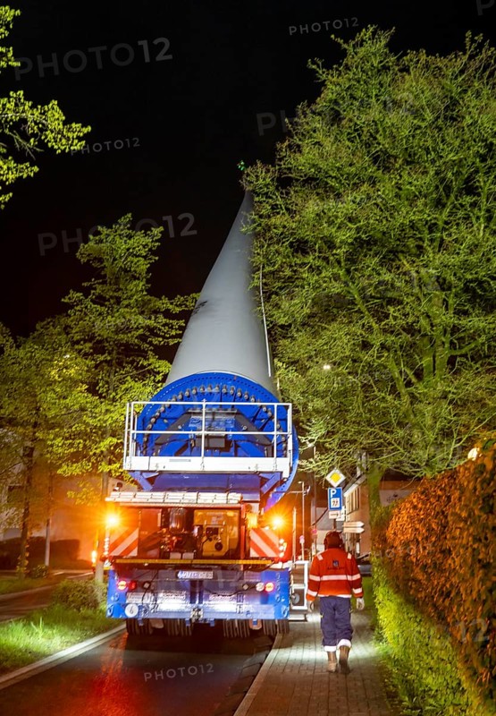 Transport of a 68 metre long, 22 tonne blade of a wind turbine, here in Breckerfeld-Waldbauer, with a self-propelled Blade-Lifter vehicle, over a 40 km long route, over 2 nights, in the Bergisches Land, through towns, villages, on country roads, narrow through roads, to the construction site of the wind turbine near Hagen, North Rhine-Westphalia, Germany, Europe