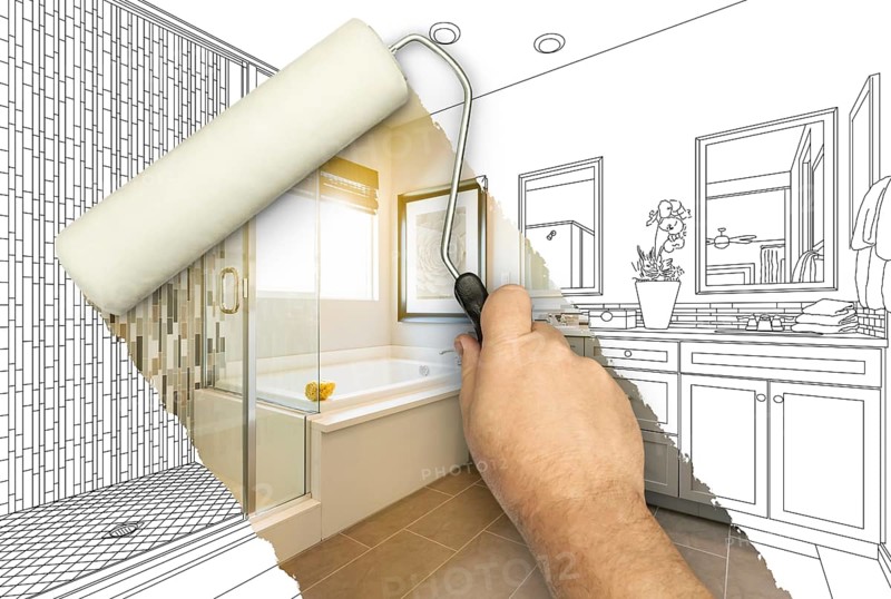 Before and after of man painting roller to reveal newly remodeled master bathroom under pencil drawing plans