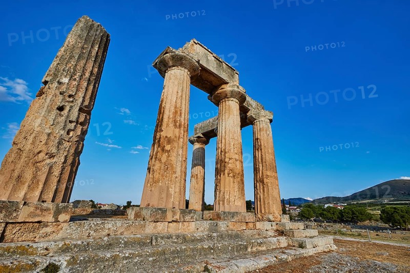 Archaic Temple of Apollo, Doric columns, Sun illuminates ancient stone columns and ruins of a temple, Archaeological site, Archea Korinthos, Corinth, Peloponnese, Greece, Europe