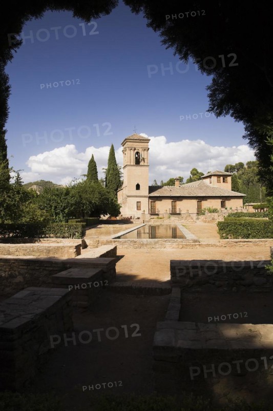 Ornamental garden with mirror water basin and a tower on the Alhambra palace grounds, Granada, Spain, Europe