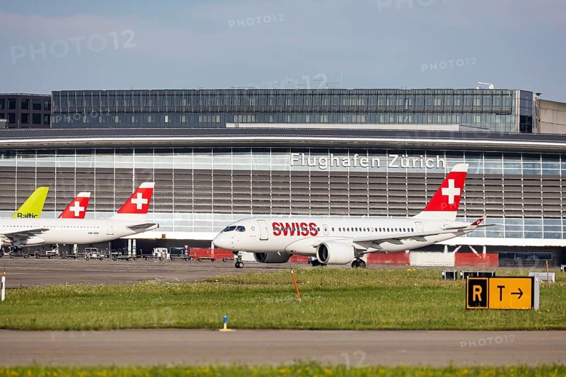 Swiss airline aircraft at Zurich Airport. Terminal and tower. Zurich, Switzerland, Europe