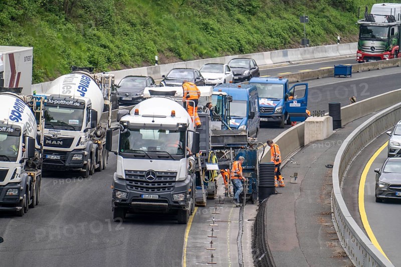 Motorway construction site on the A52 in Essen, basic renovation of the two carriageways in both directions, over 8 years, here the construction of concrete crash barriers between the carriageways, using the so-called sliding construction method, around 500 metres of concrete crash barrier, crash barrier is built per day, North Rhine-Westphalia, Essen
