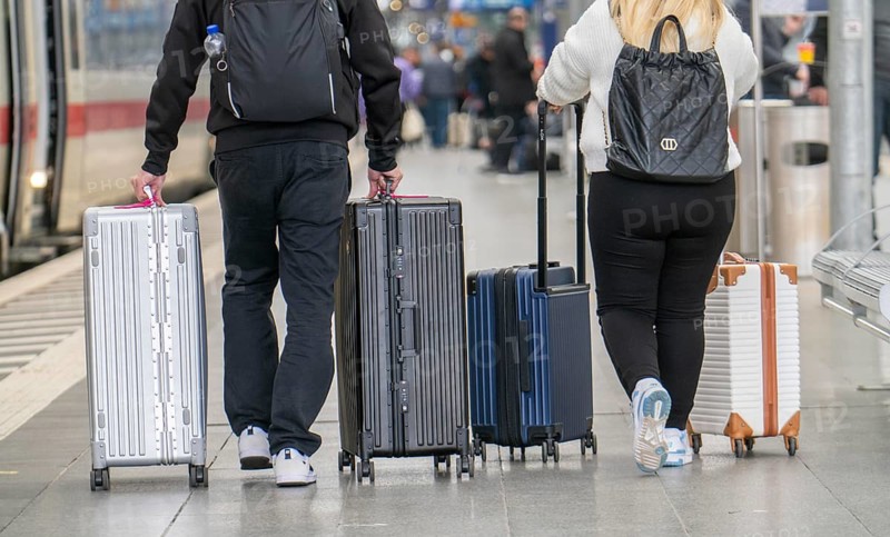 Travellers with luggage, suitcases on a platform, North Rhine-Westphalia, Germany, Europe