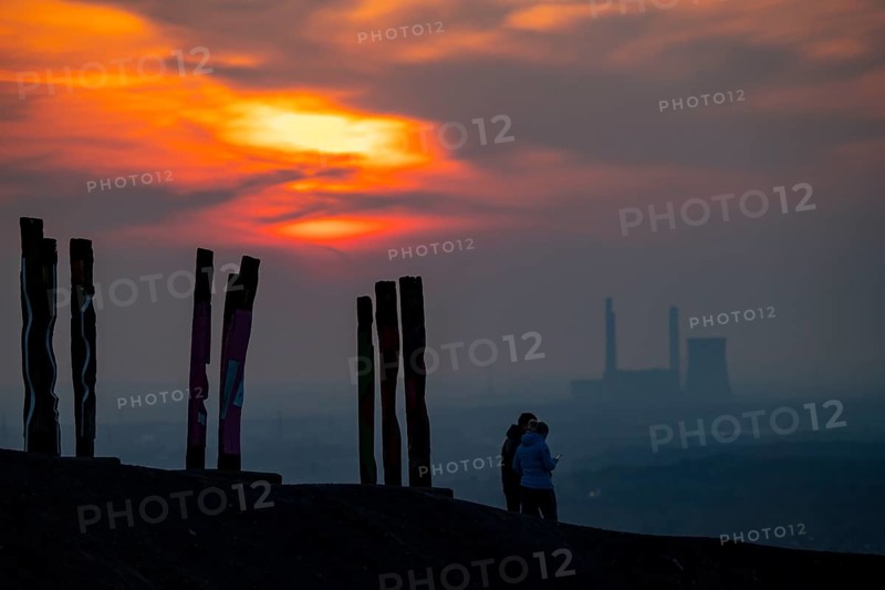 The Haniel spoil tip, 185 metre high spoil tip, at the Prosper Haniel mine, which was closed in 2019, artwork Totems by the sculptor Augustin Ibarrola, sunset, Bottrop, Germany, Europe
