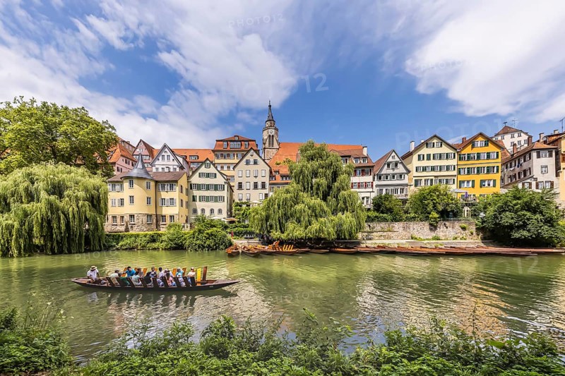 Neckarfront Tübingen with punt on the Neckar. Postcard motif with historic buildings, collegiate church and Hölderlin tower. Tübingen, Baden-Württemberg, Germany, Europe