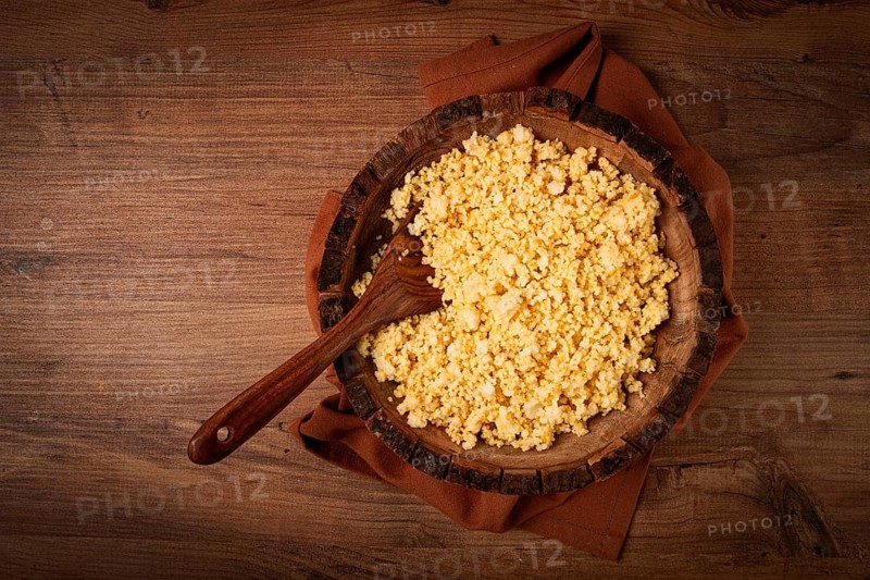 Cooked couscous, in a wooden bowl, top view, no people