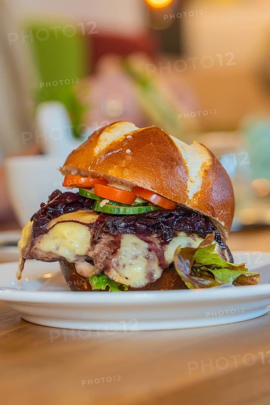 Burger with melted cheese and vegetables on a pretzel bun, autumn creations, Cafe Kuh, Deckenpfronn, Black Forest, Germany, Europe