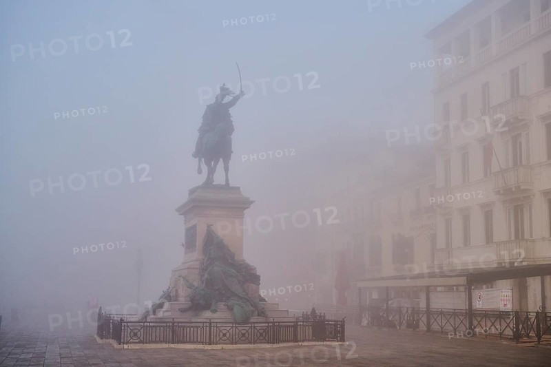 View from 'Riva degli schiavoni' on 'Monumento a Vittorio Emanuee II' before sunrise in Venice on a foggy morning in winter, Italy, Europe