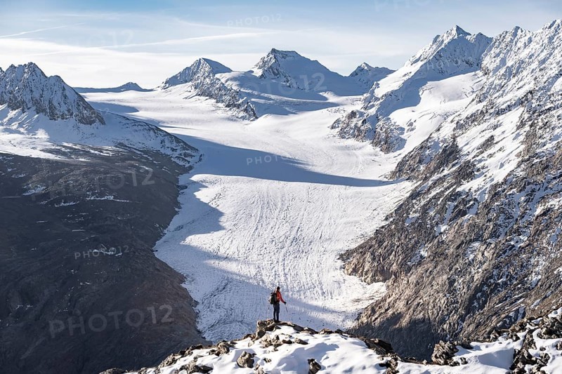 Mountaineer in front of mountain panorama and glacier, view of Gurgler Ferner with summit Hochwilde and Falschungsspitze, in the morning light, Ötztal Alps, Tyrol, Austria, Europe