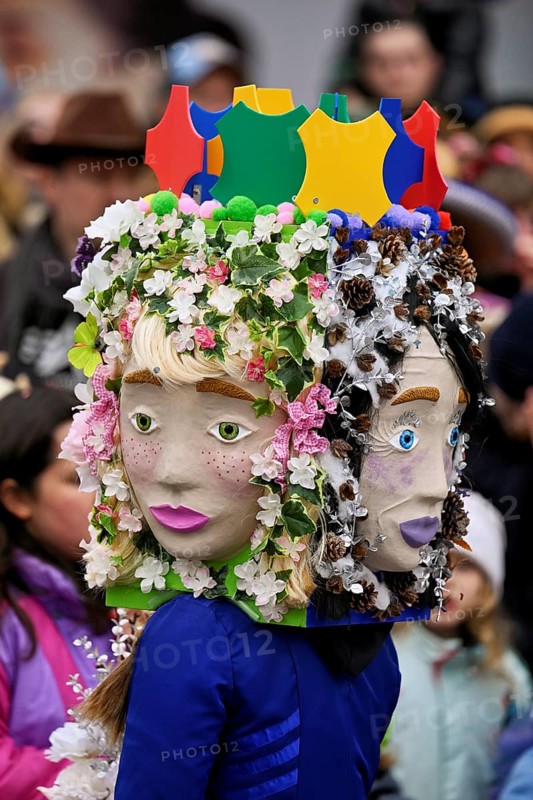 Person masked as a flower girl at the carnival parade of the Wey guild on Rose Monday, Güdismäntig, Lucerne Carnival 2024, Lucerne, Switzerland, Europe