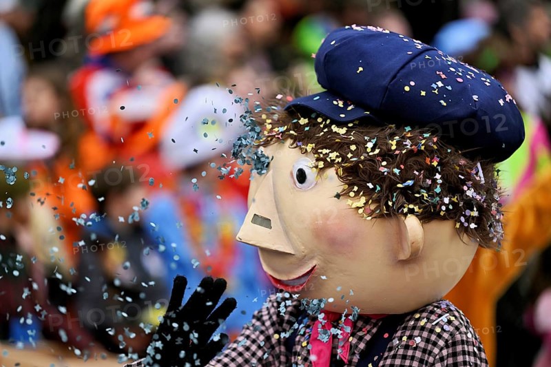 Person masked as a little boy with confetti in his hair at the carnival parade of the Wey guild on Rose Monday, Güdismäntig, Lucerne Carnival 2024, Lucerne, Switzerland, Europe