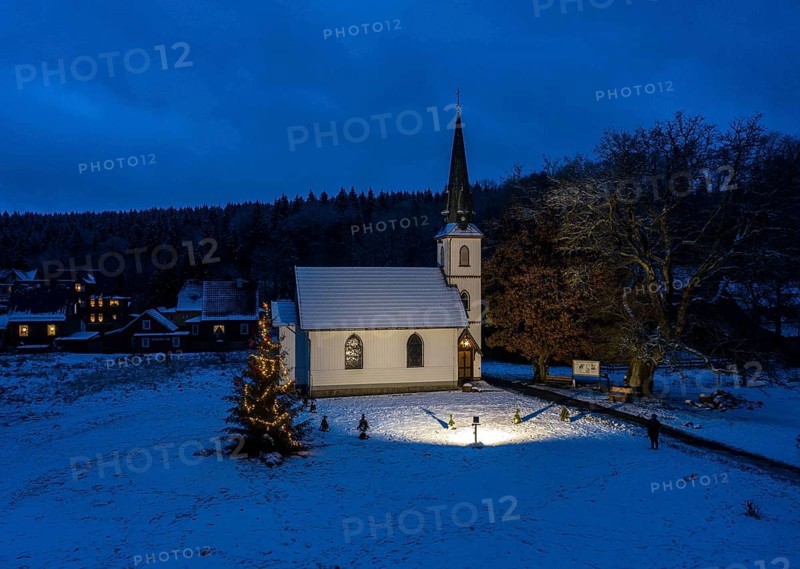 A Christmas tree stands in front of the smallest wooden church in Germany, Elend, 29 December 2020