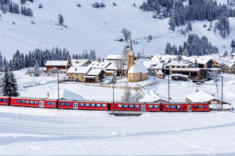 Rhaetian Railway train on the Albula railway Passenger train in the Alps in Bergün, Switzerland, Europe