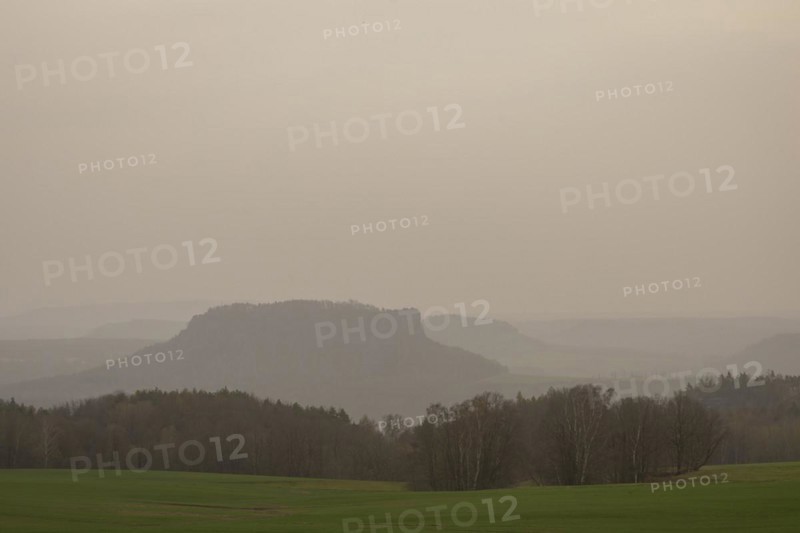 Large amounts of Sahara dust obscure the sun and cloud the distant view to Lilienstein and Pfaffenstein, Rathewalde, Saxony, Germany, Europe