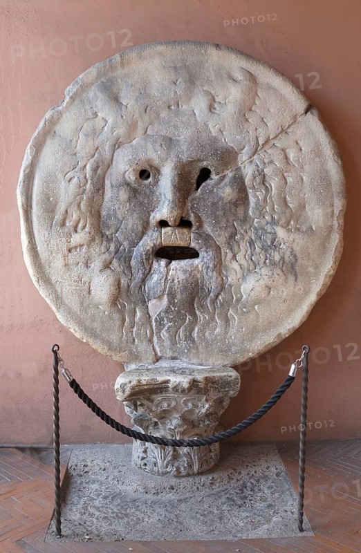 The Bocca della Verita, Mouth of Truth is a disc-shaped relief, in the portico of the Santa Maria in Cosmedin church, Rome, Italy / Mouth of Truth, Bocca della Verita, a marble mask in the portico of the Santa Maria in Cosmedin church, Rome, Italy, Europe