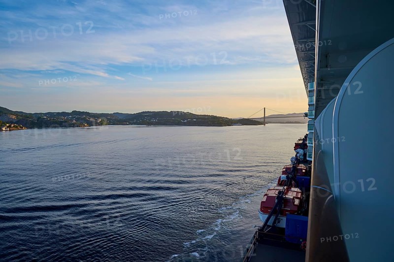 A cruise ship, Mein Schiff 6, on the calm sea, in the background a bridge and hills at sunset, Strusshamn, Bergen, Vestland, Norway, Europe