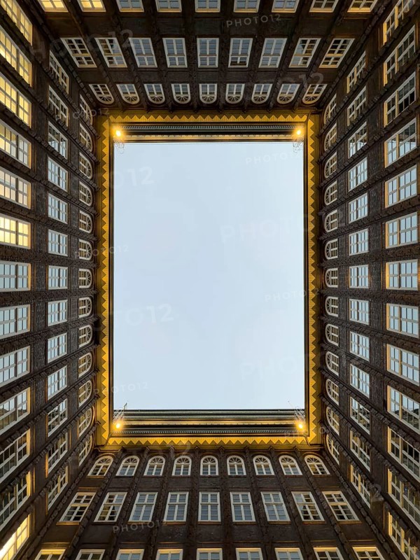 Illuminated inner courtyard of the Kontorhaus Chilehaus in Hamburg's Kontorhaus district at the blue hour, Hamburg, Germany, Europe