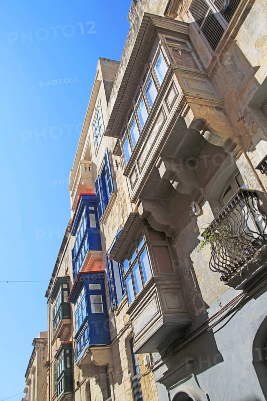 Balconies of houses historic street in city centre of Valletta, Malta, Europe