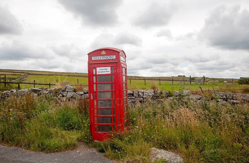 Red telephone box booth on moorland near Princetown, Dartmoor national park, Devon, England, UK