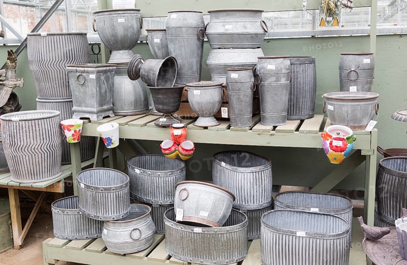 Display of metal planting containers, The Walled garden plant nursery, Benhall, Suffolk, England, UK