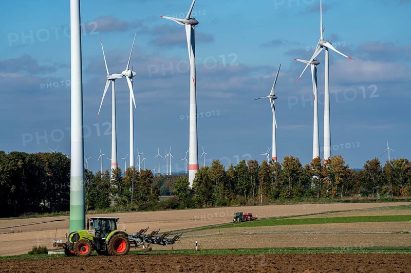 Farmer working in the fields, with a tractor, wind farm above the village of Lichtenau, self-proclaimed energy town, Paderborn district, OWL, A North Rhine-Westphalia, Germany, Europe