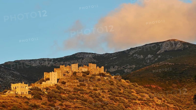 Sunset illuminates the historic buildings and the hilly landscape, Vathia, residential tower village, Mani peninsula, Peloponnese, Greece, Europe