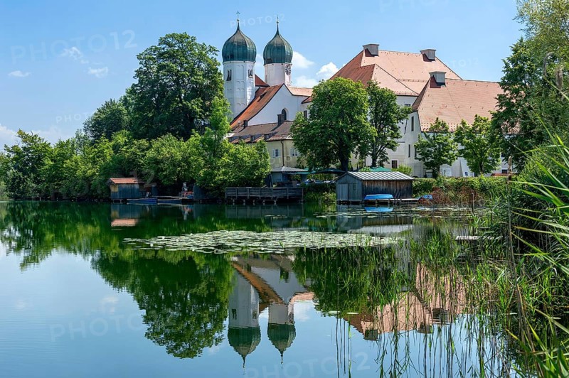 Romanesque Benedictine abbey Seeon monastery, monastery church St. Lambert, reflection in the monastery lake with water lilies (Nymphaea), calm smooth water, Seeon-Seebruck, Chiemgau, Upper Bavaria, Bavaria, Germany, Europe