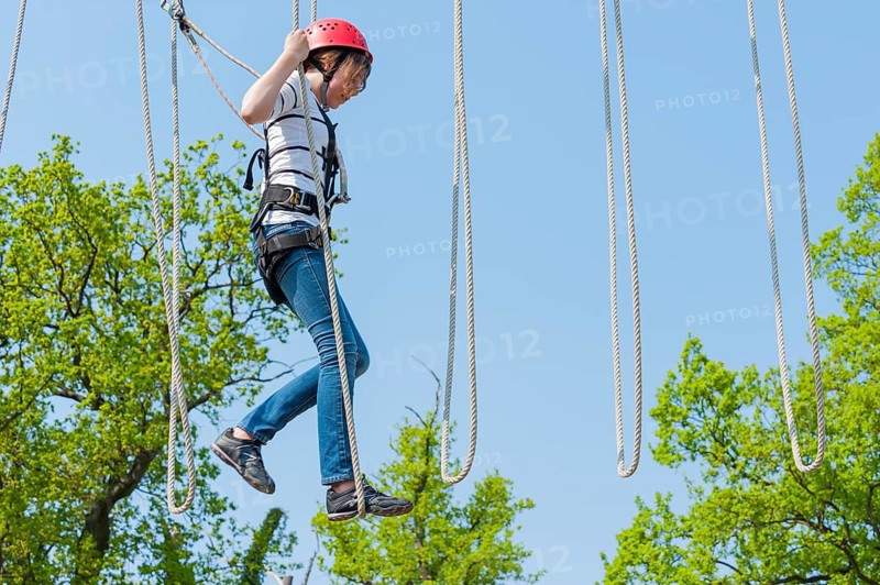 Young girl in climbing park, climbing, action, safety, belay, belay rope, belay technique, belay hook, courage, brave, leisure, hobby, height, fear of heights, overcoming, sport
