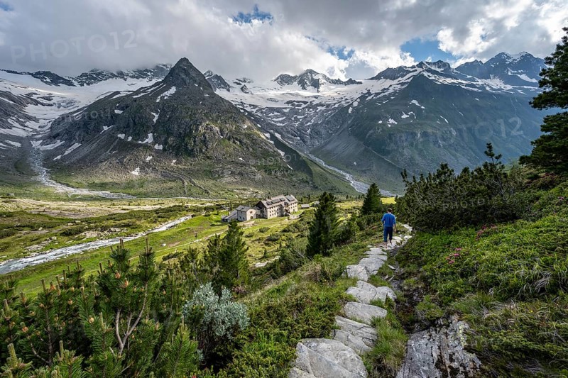 Mountaineer barefoot on a hiking trail, mountain hut Berliner Hütte, mountain peak Steinmandl, glacier Waxeggkees and Hornkees, Berliner Höhenweg, Zillertal Alps, Zillertal, Tyrol, Austria, Europe
