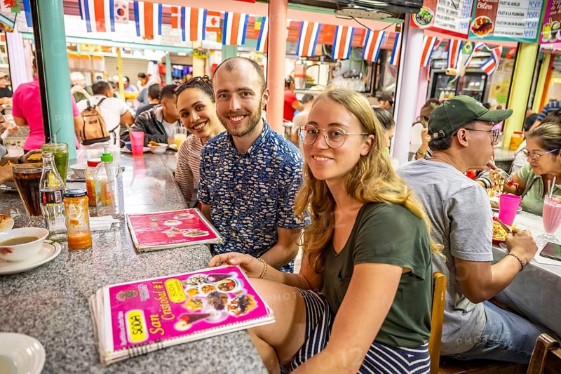 Tourists sitting at a table at a food stall, Mercado Central de San José, San José, Costa Rica, Central America