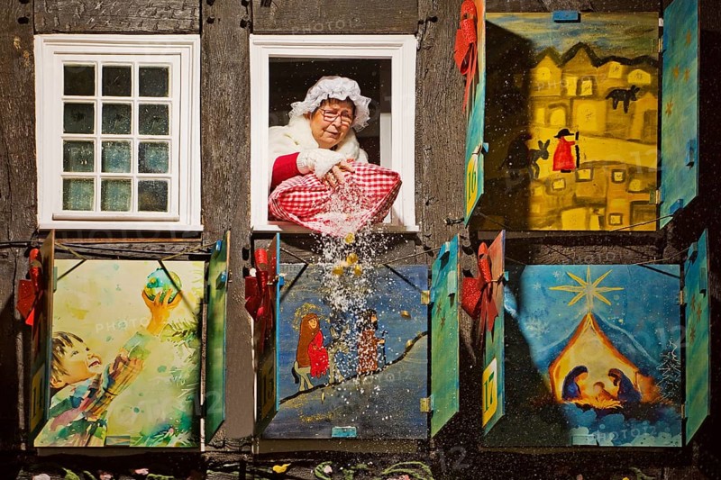 Mrs Holle shakes out her pillow of gold coins at the large Advent calendar at the Old Town Hall, Nostalgic Christmas Market, Hattingen, North Rhine-Westphalia, Germany, Europe
