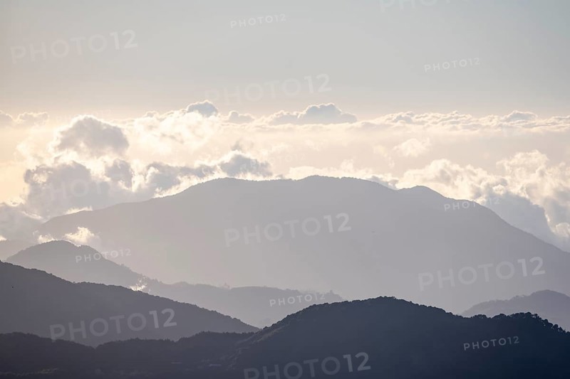 View of hills with cloud forest, Dramatic clouds between the mountains, Province of San José, Costa Rica, Central America