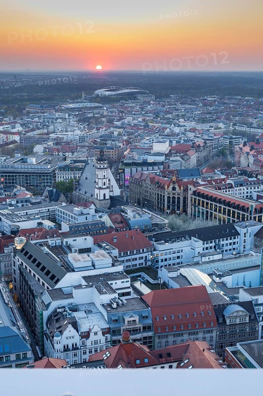 View of the city from the City Tower at sunset, St Thomas' Church, Red Bull Arena and Auwald forest, Leipzig, Saxony, Germany, Europe