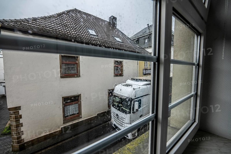 City centre traffic, lorry driving through the town of Breckerfeld, narrow passage in Frankfurter Straße, right next to the residential buildings, Ennepe-Ruhr district, North Rhine-Westphalia, Germany, Europe