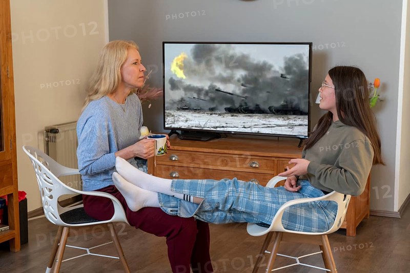 Mother and daughter, teenage, 13 years old, in a confidential conversation, at home, talking about fears, in connection with war, flight