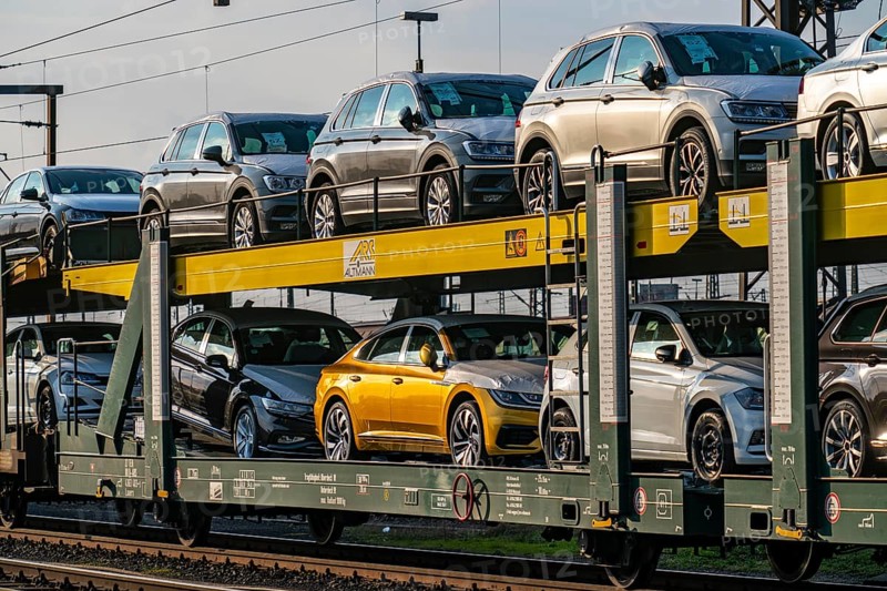 VW plant, Emden, new cars, car transporter, car train, goods train, with VW vehicles, Lower Saxony, Germany, Europe