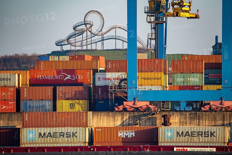 Container Handling Centre, Gateway West Terminal, Logport 2, cargo ship, in Duisburg on the Rhine, in the background Tiger and Turtle - Magic Mountain is a landmark modelled on a roller coaster on Heinrich-Hildebrand-Höhe in Angerpark in Duisburg-Angerhausen, North Rhine-Westphalia, Germany, Europe