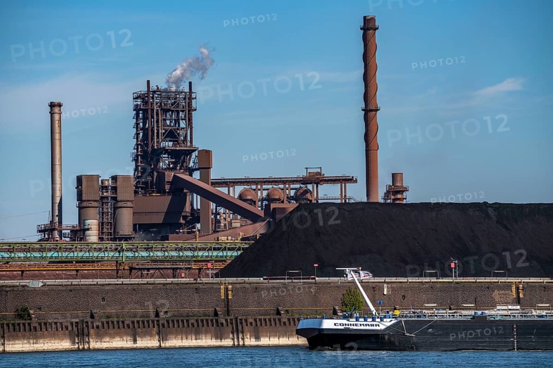 ThyssenKrupp steelworks in Duisburg-Marxloh, blast furnace Schwelgern 2, coal store of the Schwelgern coking plant, cargo ship on the Rhine, Duisburg, North Rhine-Westphalia, Germany, Europe