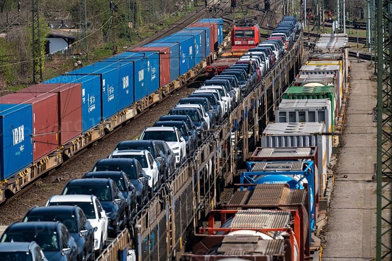 Duisburg-Rheinhausen freight station, at the Logport harbour area, goods trains loaded with new cars, various tank containers and the container train from China, on its way to the Logport, part of the new Silk Road, Duisburg, North Rhine-Westphalia, Germany, Europe