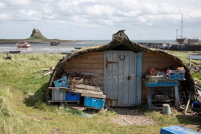 Upturned boats used as storage shed, Holy Island, Lindisfarne, Northumberland, England, UK