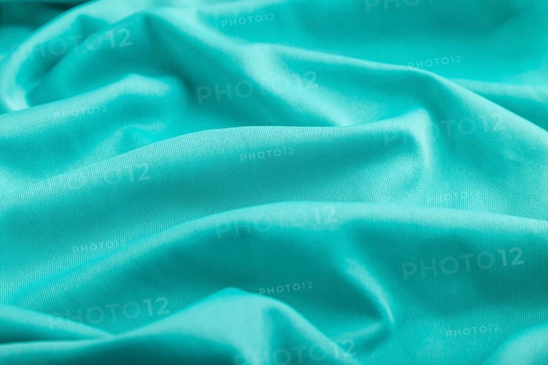Fragment of silk blue tissue. Side view, natural textile background and texture. wave concept, abstract