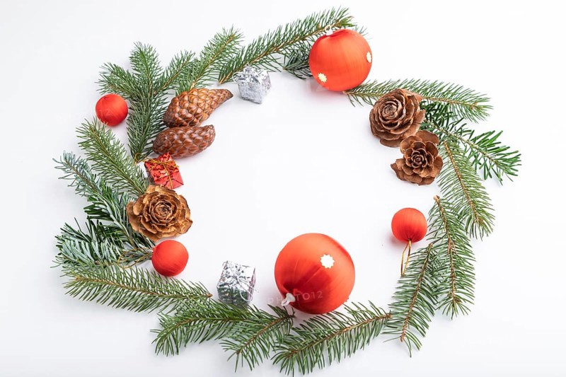 Christmas or New Year wreath composition. Decorations, balls, cones, fir and spruce branches, on white background. Side view, copy space