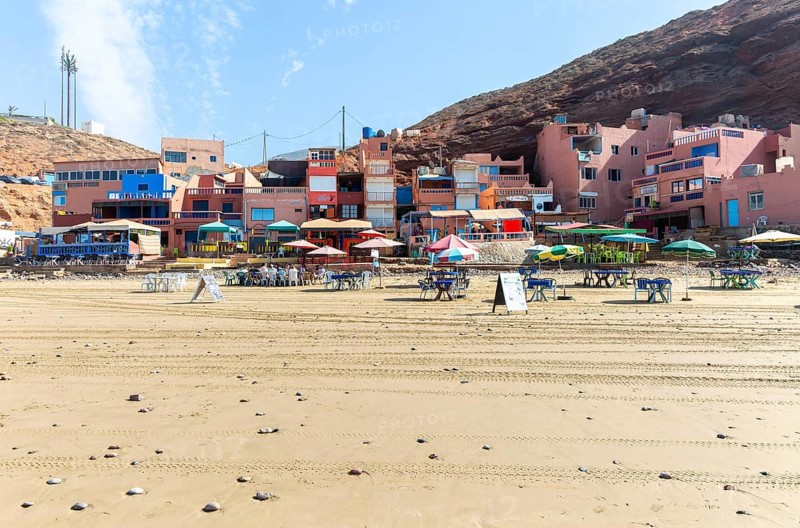 Sandy beach and buildings, Legzira, southern Morocco, north Africa