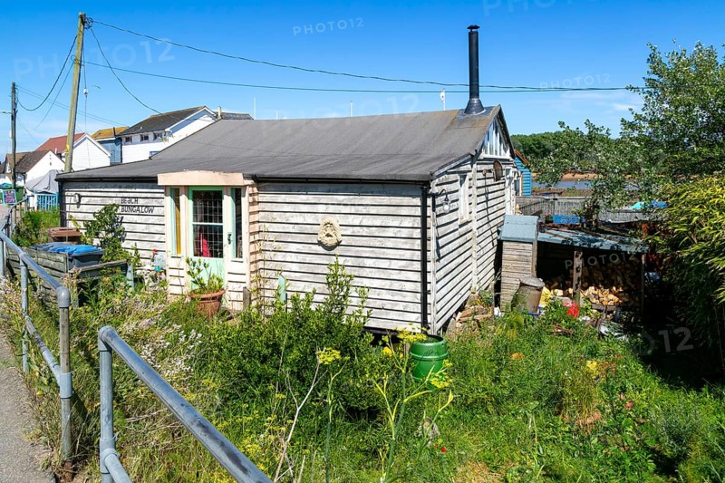Seaside chalet beach bungalow buildings at Felixstowe Ferry, Suffolk, England, Uk
